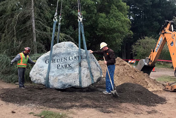 Workers lower Golden Gate Boulder sign